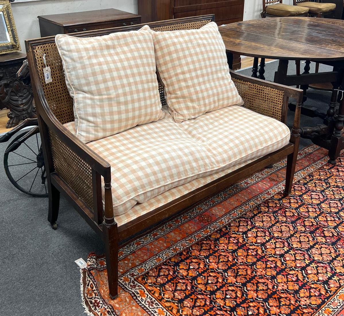 An Edwardian George III style mahogany Bergere settee with loose cushion seat and back, width 120cm, depth 62cm, height 95cm